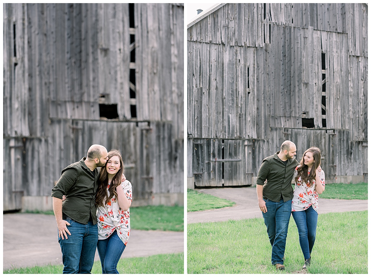 engaged couple standing in front of barn