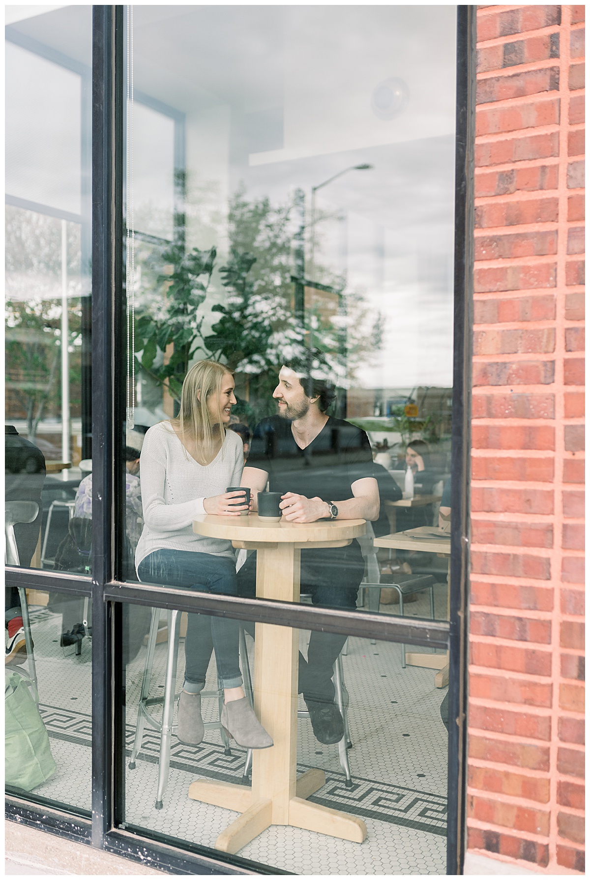 engaged couple coffee shop window