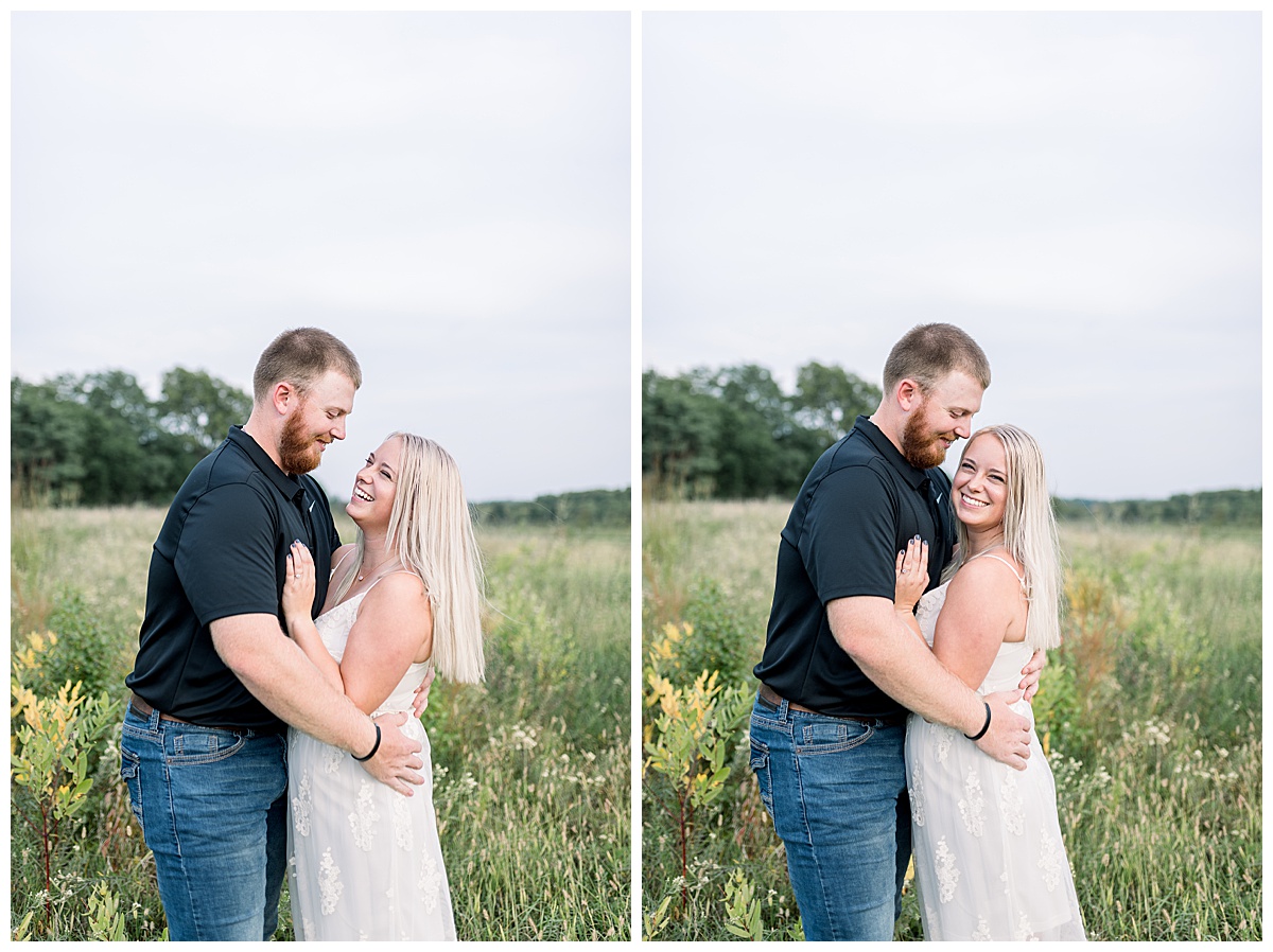 couple smiling in field shawnee mission park engagement