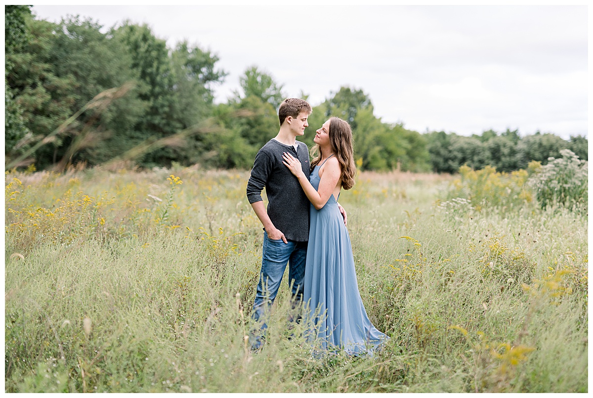 engaged couple in field