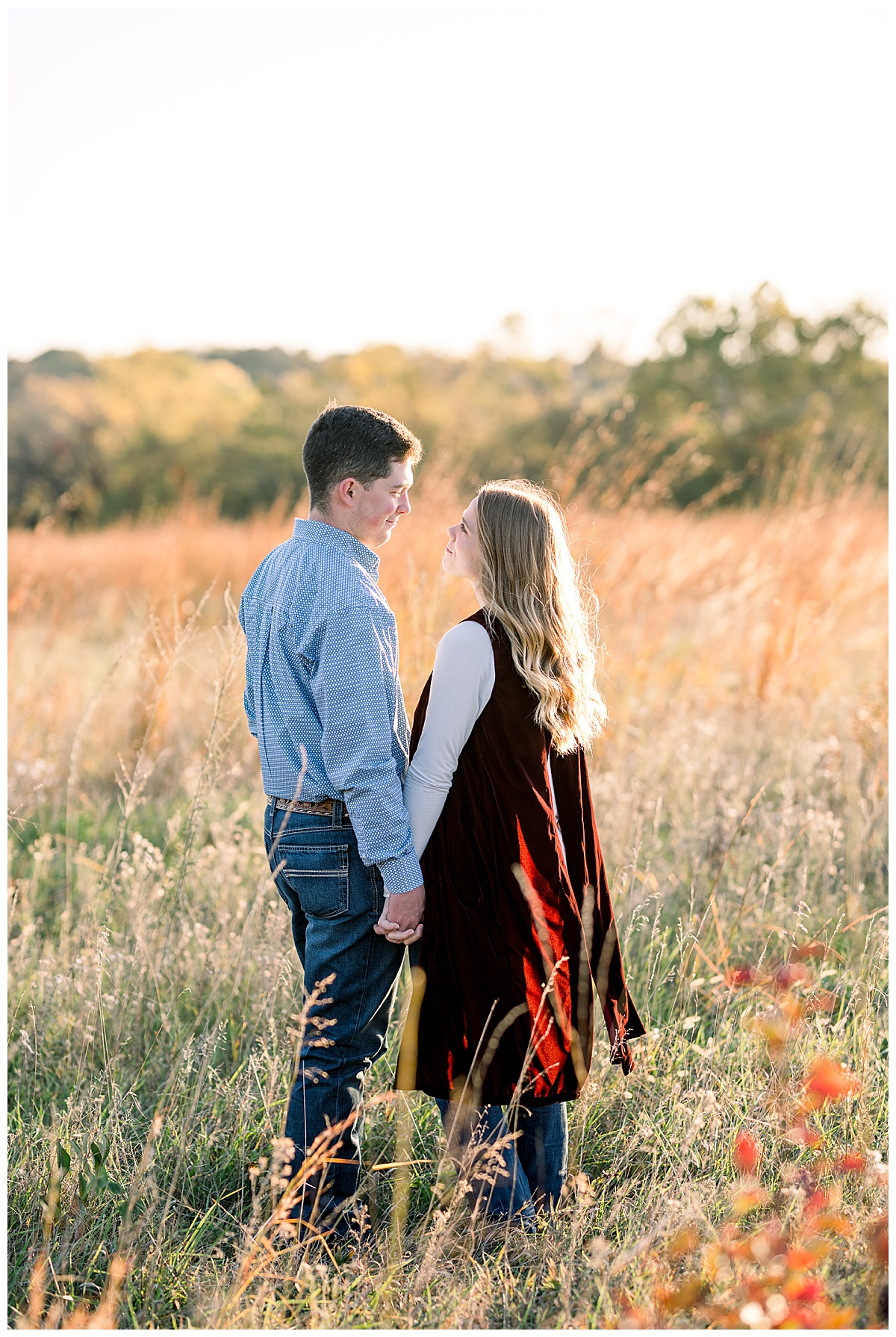 Shawnee Mission Park Engagement holding hands in field